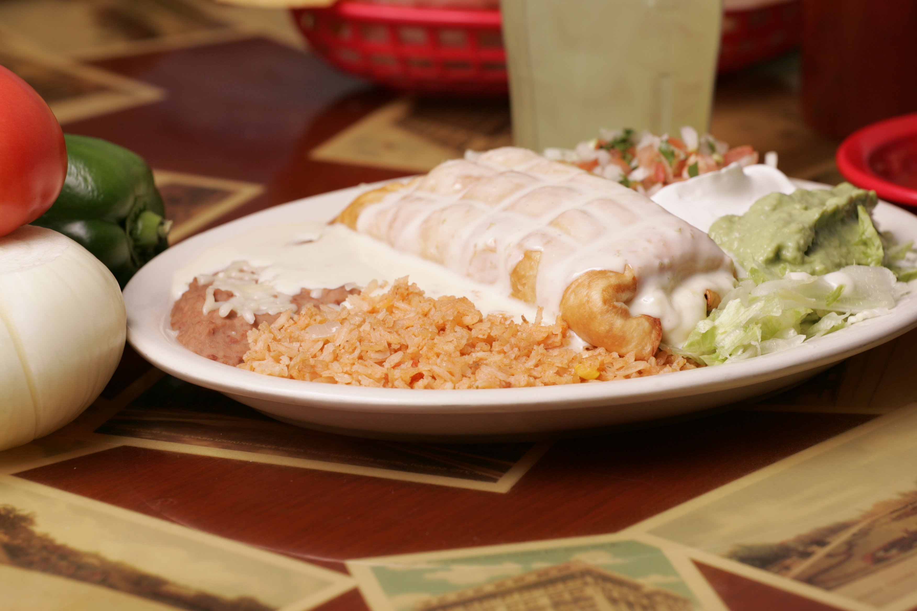 Chimichangas with cheese sauce and Mexican rice at El Vaquero